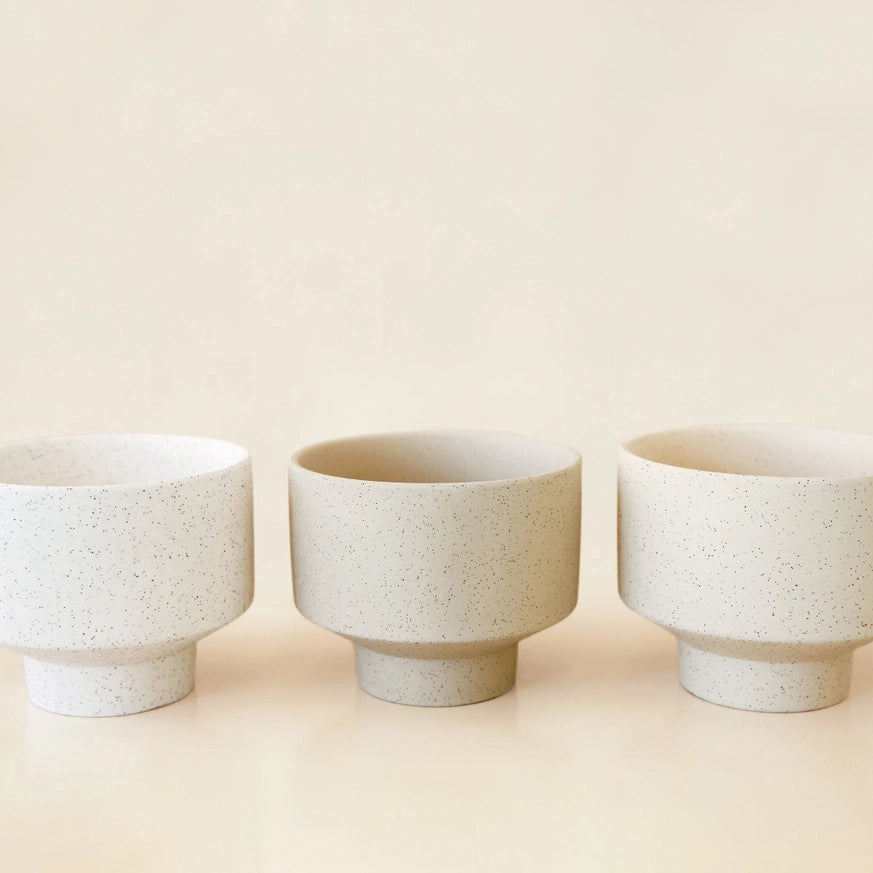 Image of three cream colored ceramic pots that are used to demonstrate the type of planters that could be drilled using this service. 