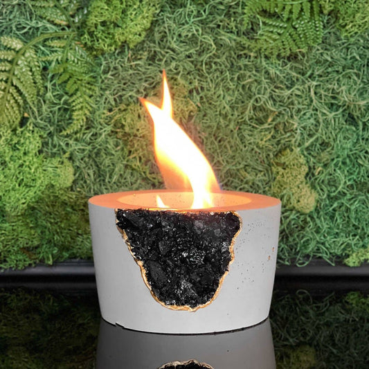 Lit concrete tabletop fire pit with black tourmaline stone 